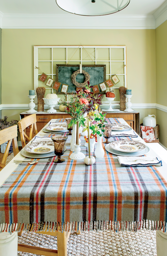 mid century farmhouse dining room table covered in vases and plaid table cloth