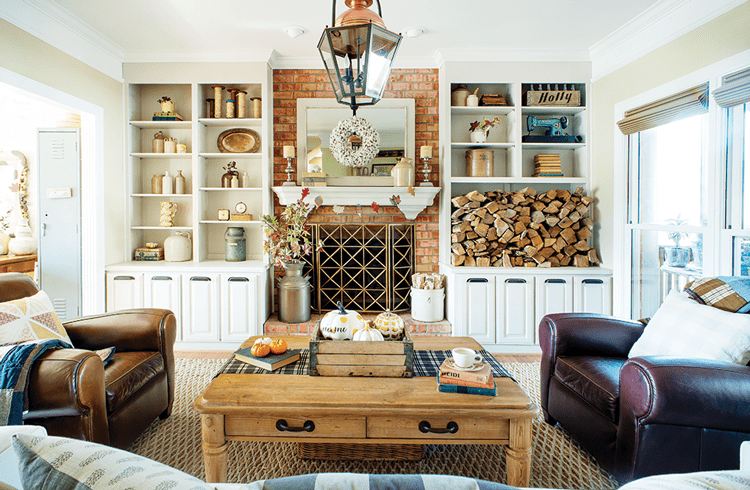 Midcentury farmhouse living room with leather seats, rustic coffee table and brick fireplace with a modern gold grate. All things that need a deep clean.