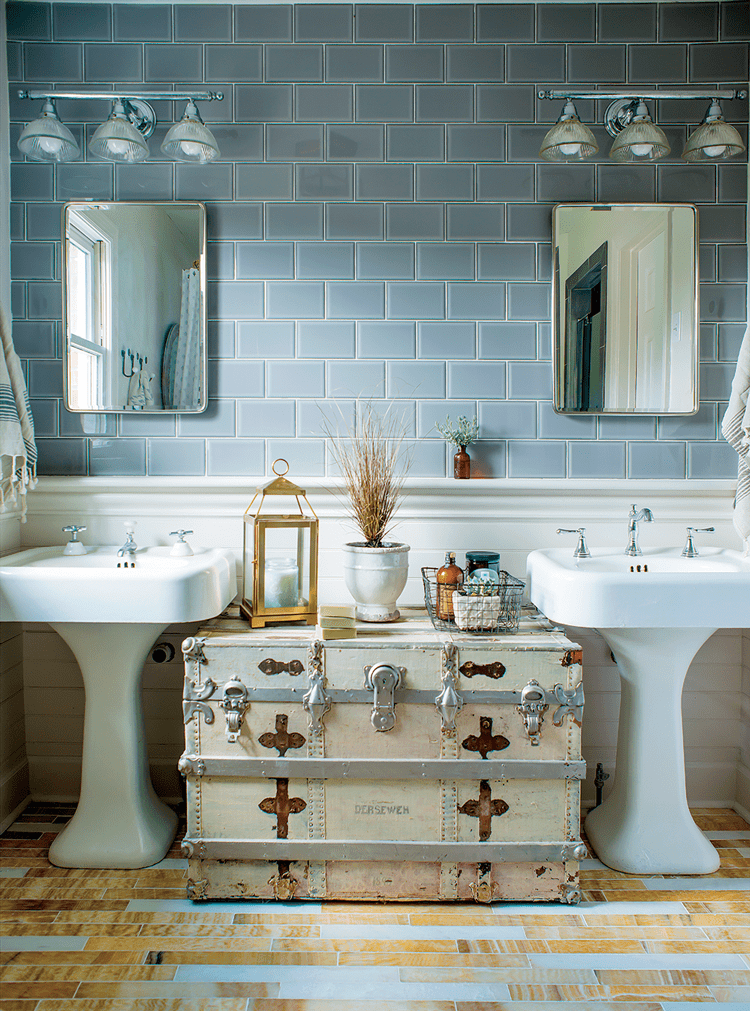 mid century farmhouse master bathroom with pedestal sinks subway tile and vintage chest