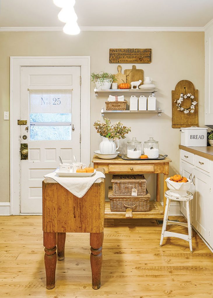 kitchen with vintage butcher block countertop in flea market inspired farmhouse