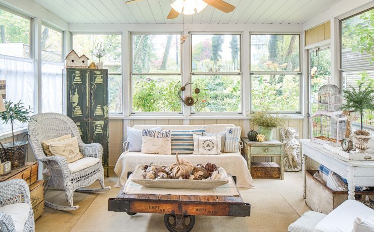 enclosed porch decorated for fall