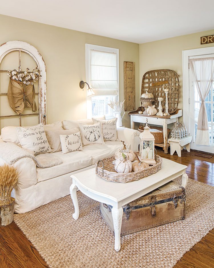 living room with white couch and coffee table in flea market inspired farmhouse