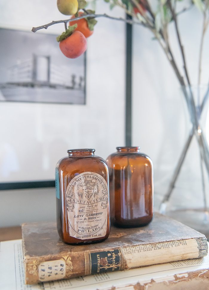 Brown glass bottles on top an old book.