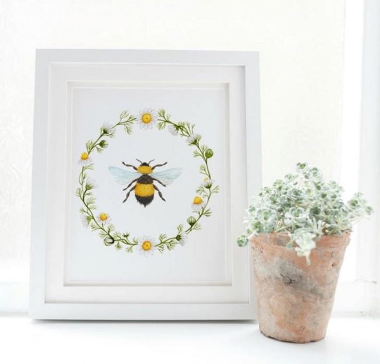 A sweet print of a honeybee and daisy chain.
