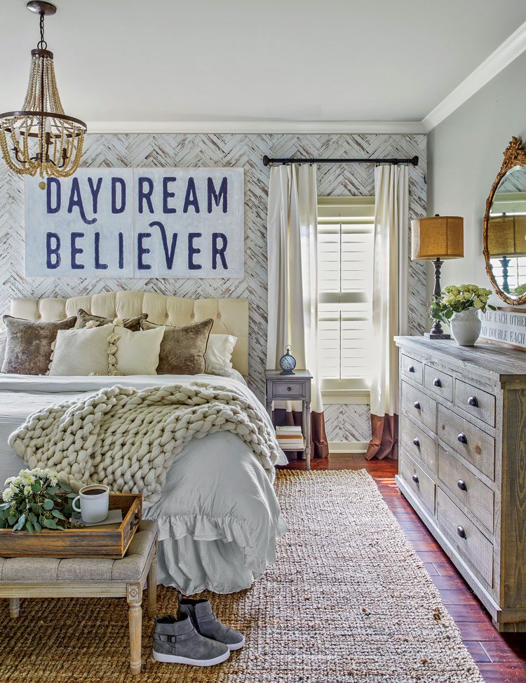 fall farmhouse master bedroom with wall paper white bed and vintage dresser