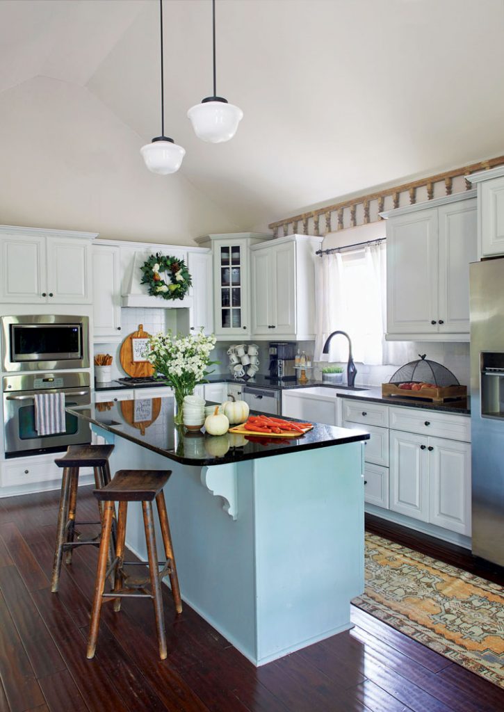 fall farmhouse kitchen with blue island and white cabinets