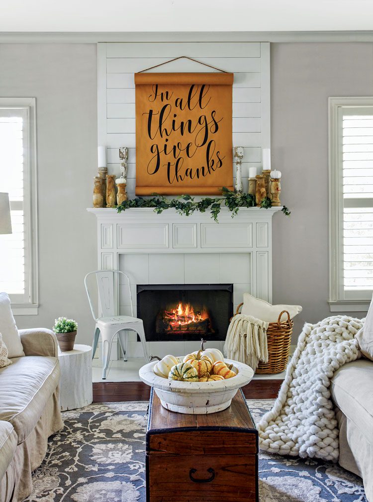 fall farmhouse living room with white fireplace and quote on mantel