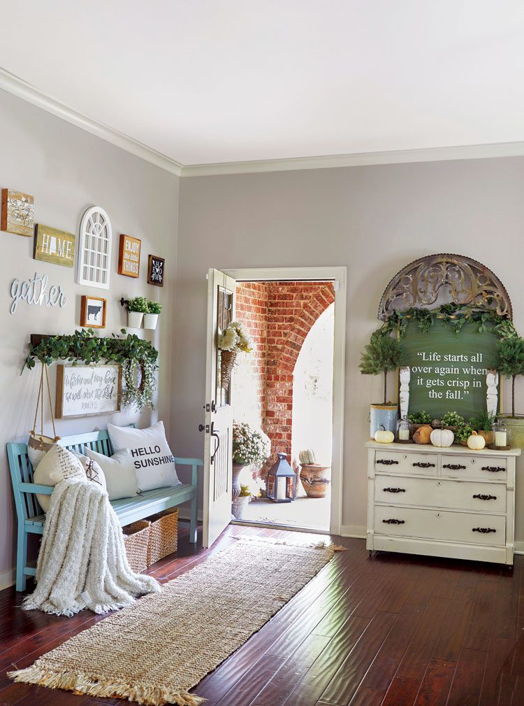 fall farmhouse entryway with bench dresser and gallery wall
