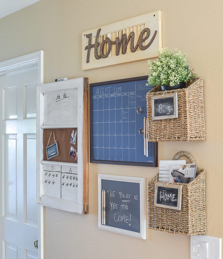 A chalkboard calendar, cork board and whiteboard to write notes on. There are also two baskets to organize mail and other papers.