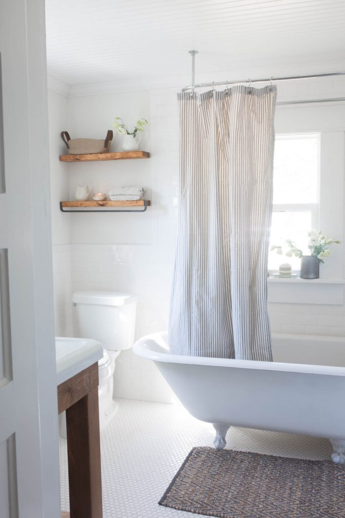 farmhouse bathroom bathtub with shower and window