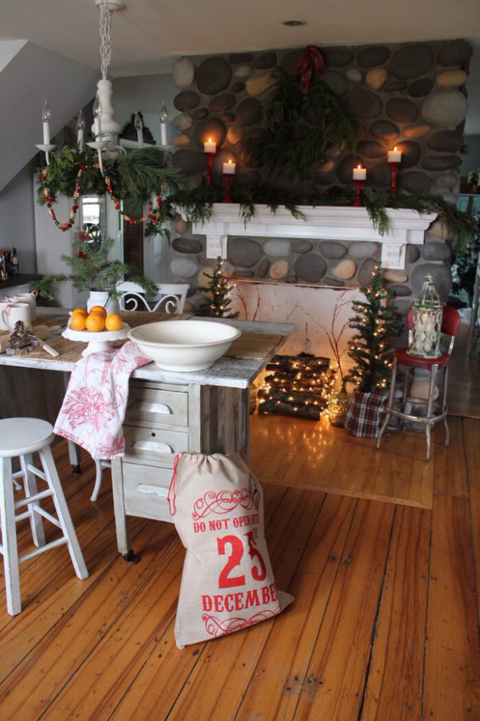 Faux fireplace with fresh garlands and Christmas decorations