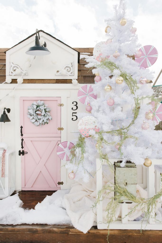 front of the playhouse with white tree and pink ornaments