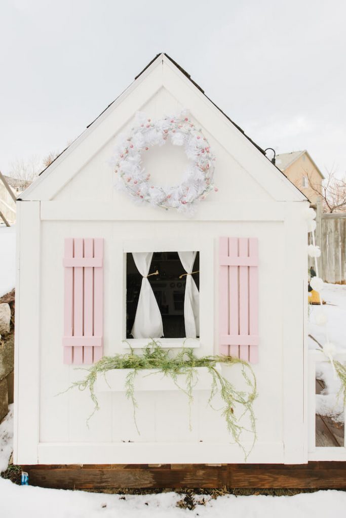 The side of the playhouse with pink shutters