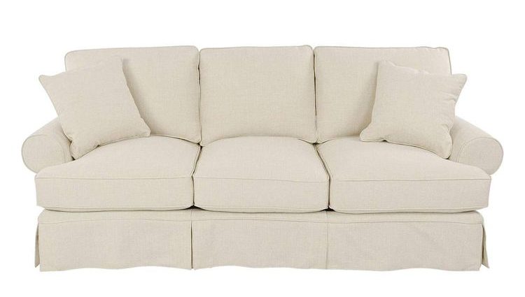 Off-white plush fabric sofa with two matching pillows.