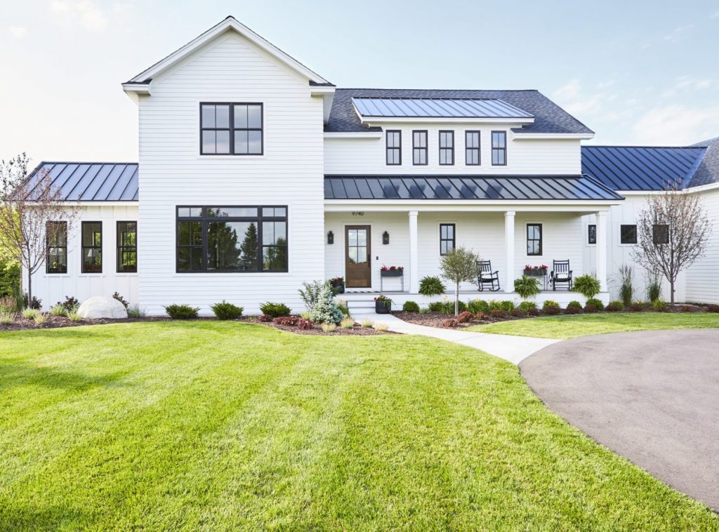modern farmhouse style exterior with black windows and aluminum roof