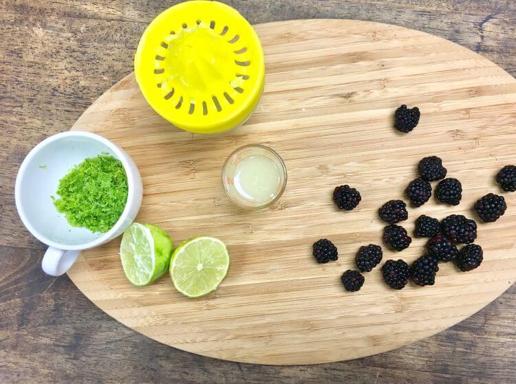 Limes and blackberries on cutting table
