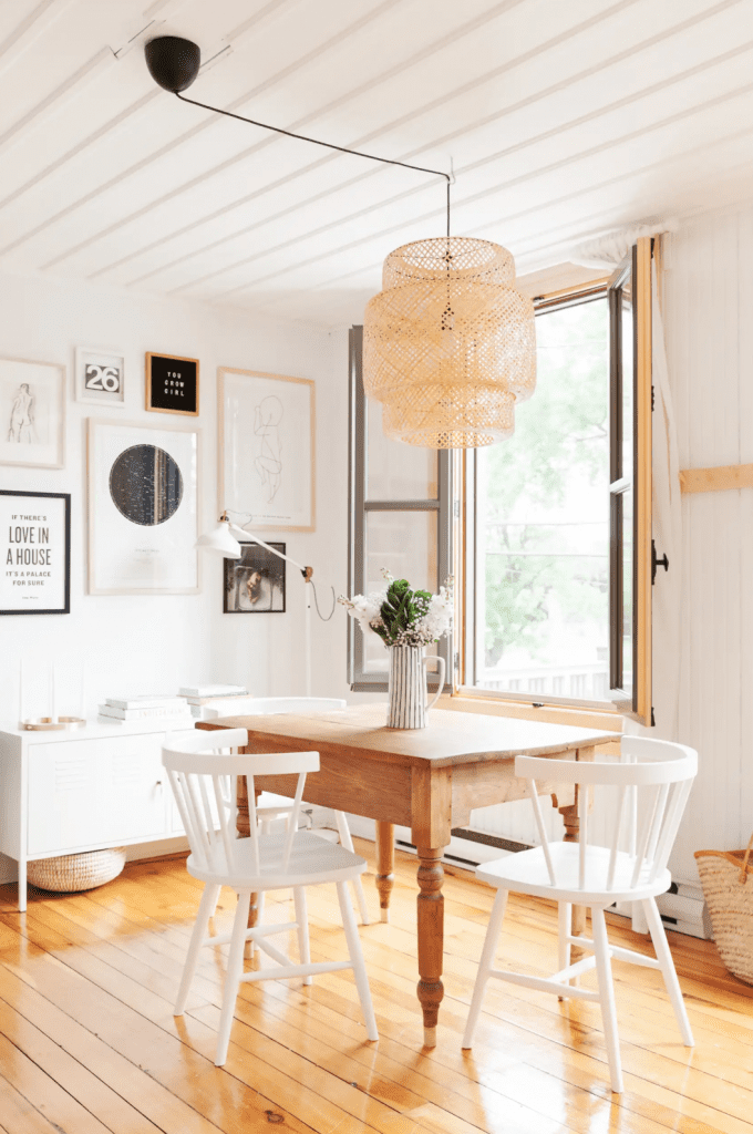 rustic Scandinavian farmhouse style dining room with vintage table windsor chairs and wood flooring