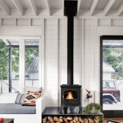 wood burning stove in living room with large window scandinavian farmhouse style