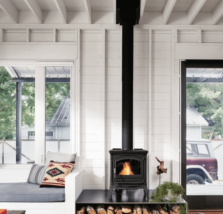 wood burning stove in living room with large window scandinavian farmhouse style
