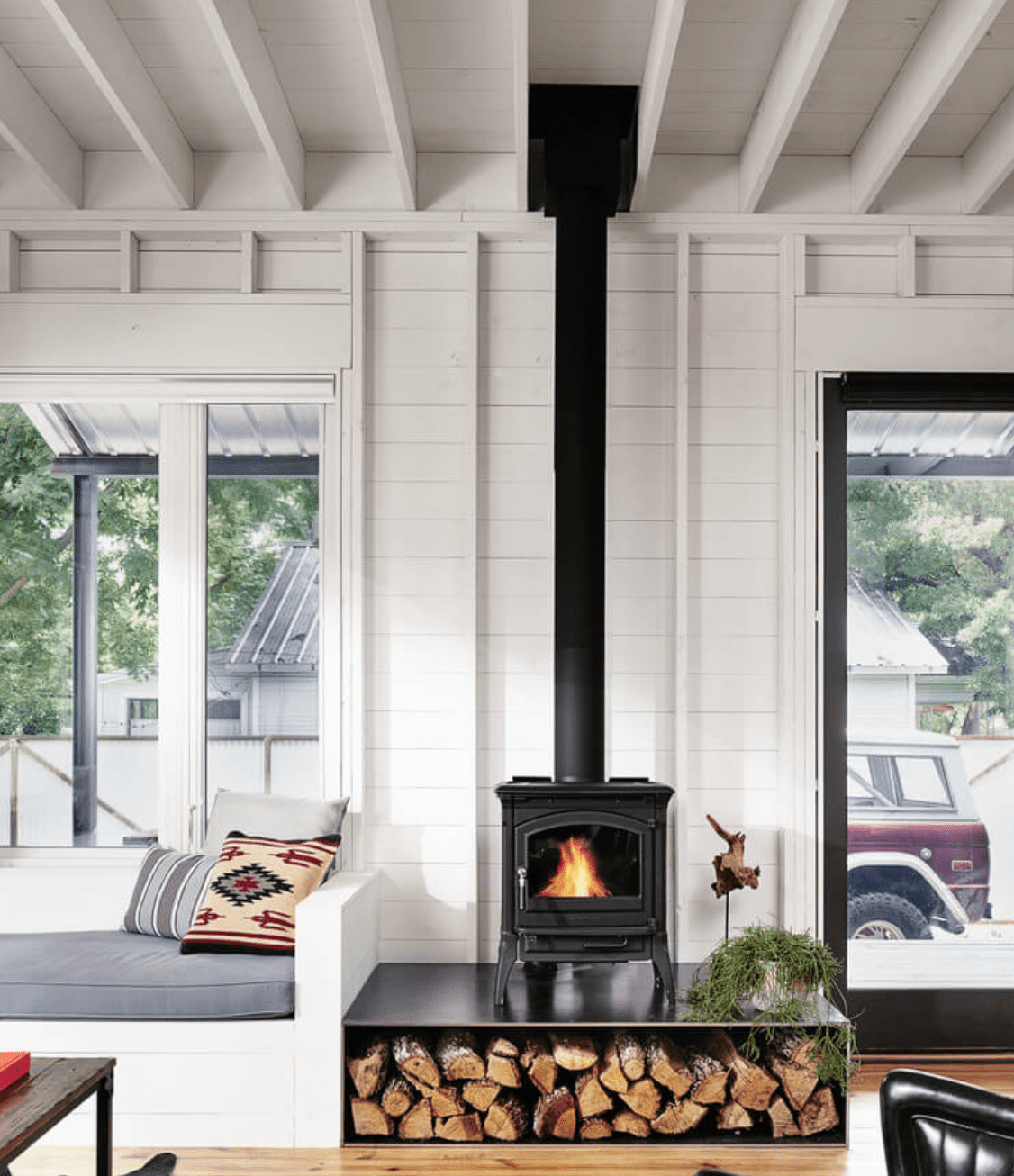 wood burning stove in living room with large window scandinavian farmhouse style