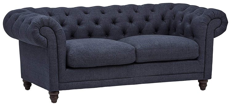 Navy blue fabric tufted loveseat with curved armrests.