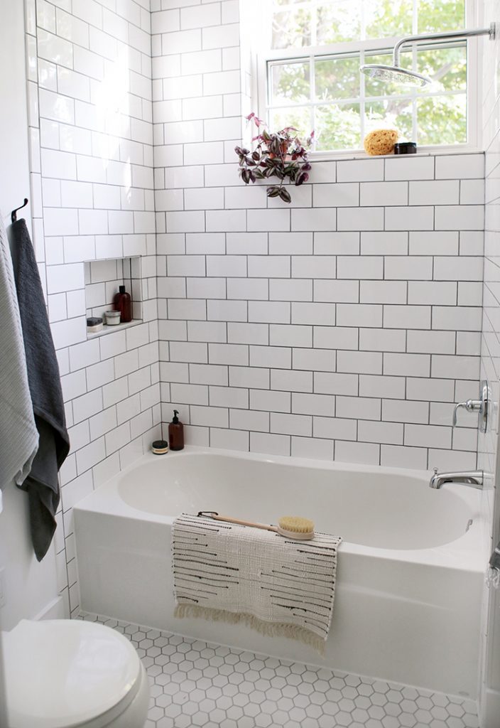 farmhouse bathroom bathtub with shower and subway tile backsplash