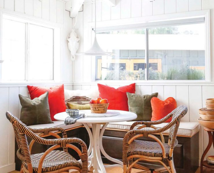 bright dining nook with built in bench and white table in ranch renovation