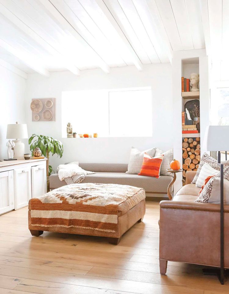 living room with beige couch, post and beam ceilings, wood floor in ranch renovation