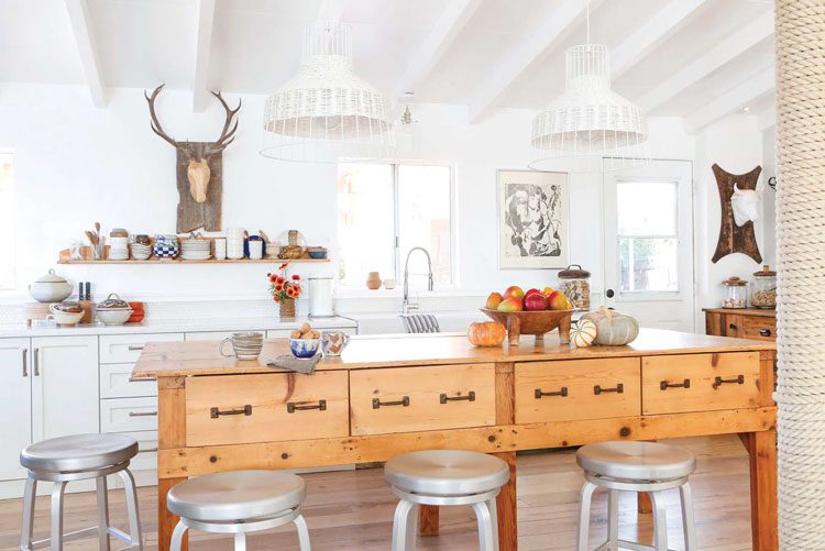 Open and airy kitchen with wooden island in ranch renovation