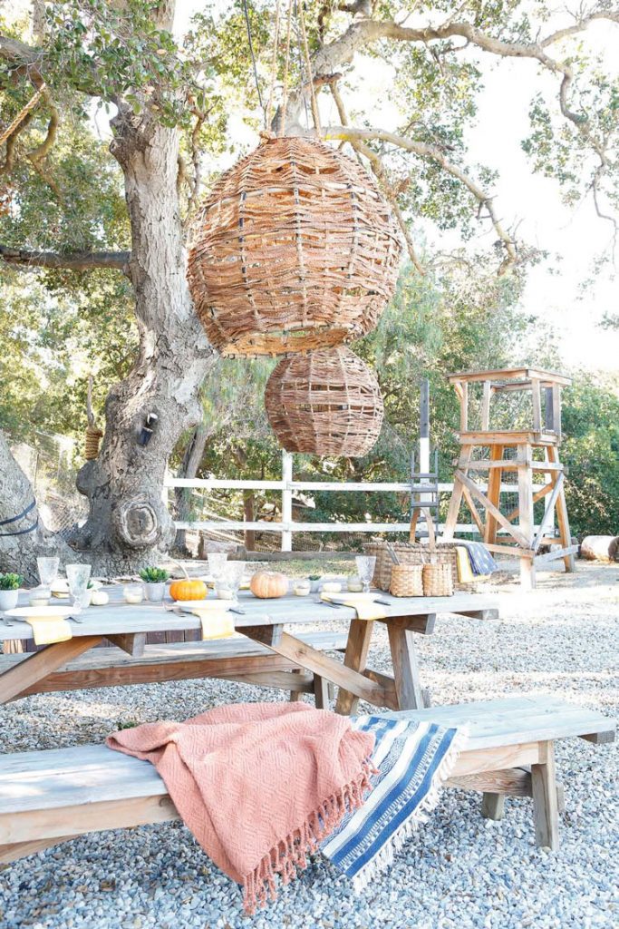 Open outdoor space with picnic table and hanging lights in ranch renovation