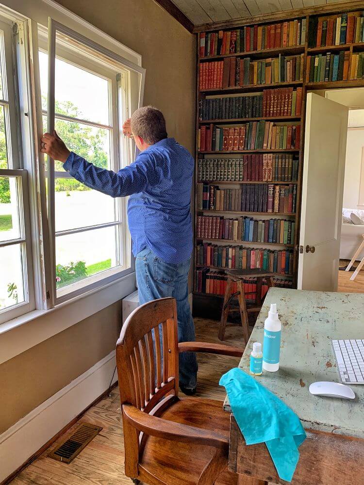 A man measures his window