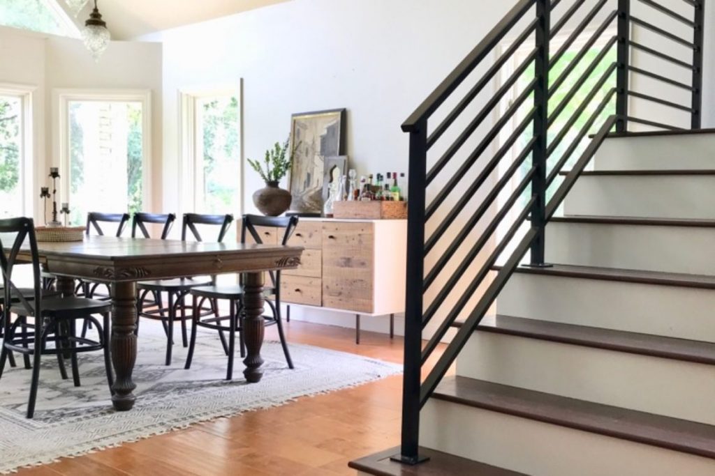 modern staircase with metal railings in dining room