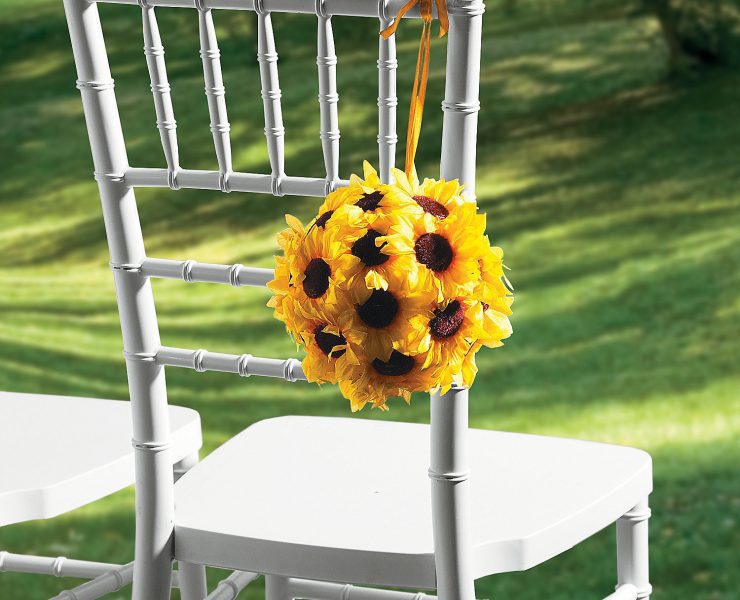 7” diameter ball composed of sunflowers, hanging over the back of a white chair at a country bridal shower