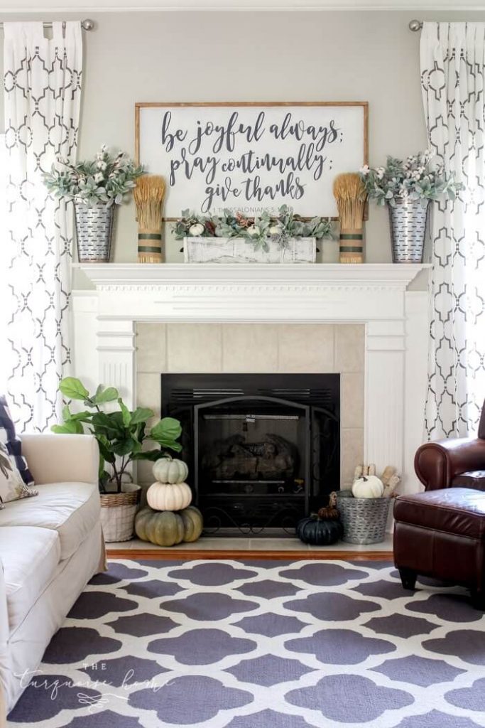 Fall mantel with Scripture sign art, pumpkins, cotton and wheat stalks.