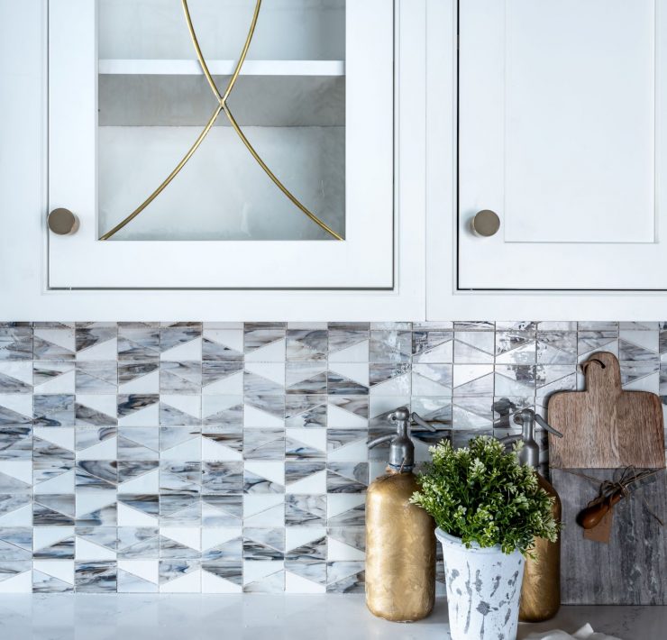 white inset cabinetry with brass radius glass doors