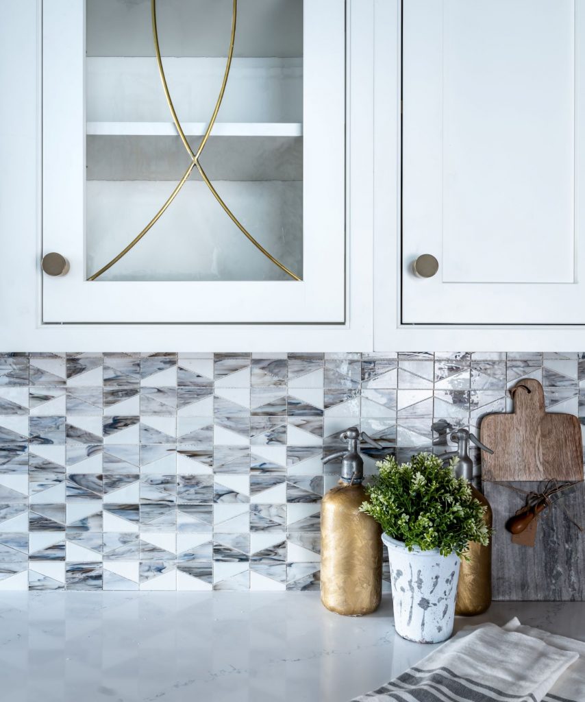 white inset cabinetry with brass radius glass doors