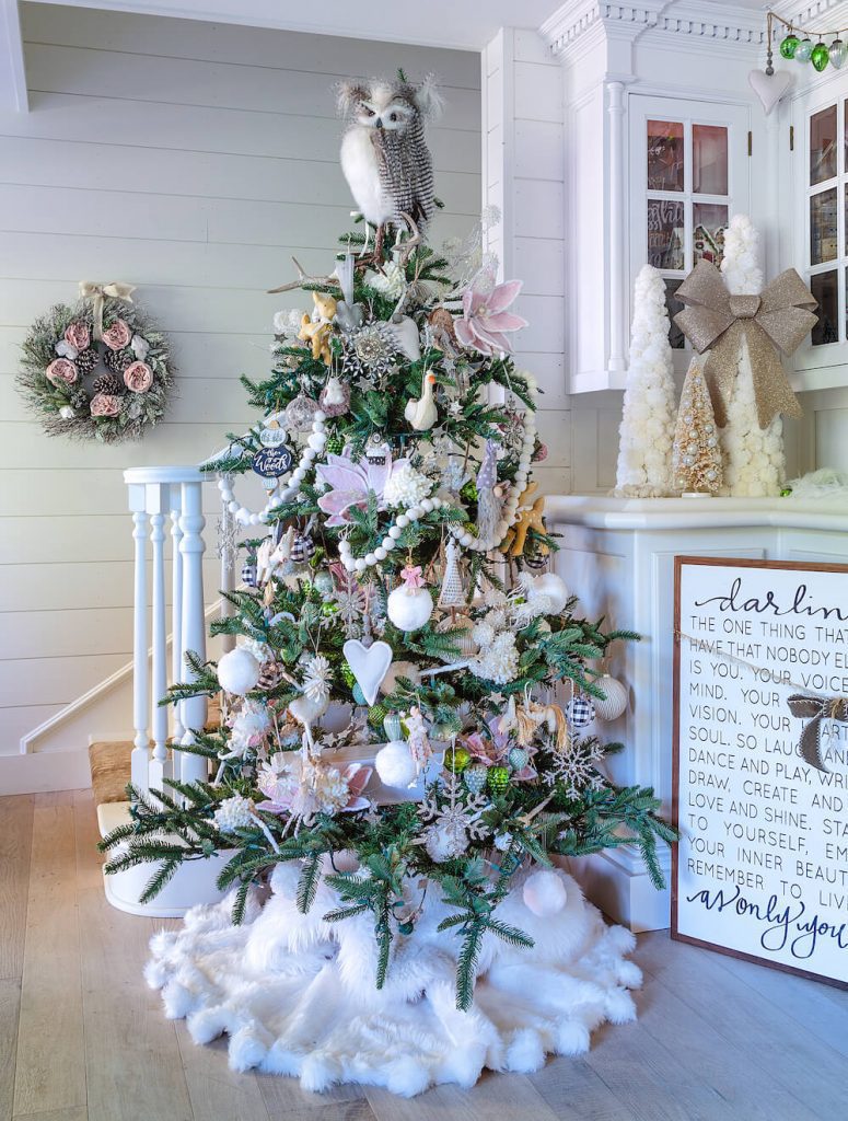 Christmas tree decorated in white and pink with woodland owl topper.