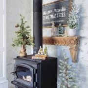 Rustic wood stove with Christmas Trees sign for a woodland Christmas theme.
