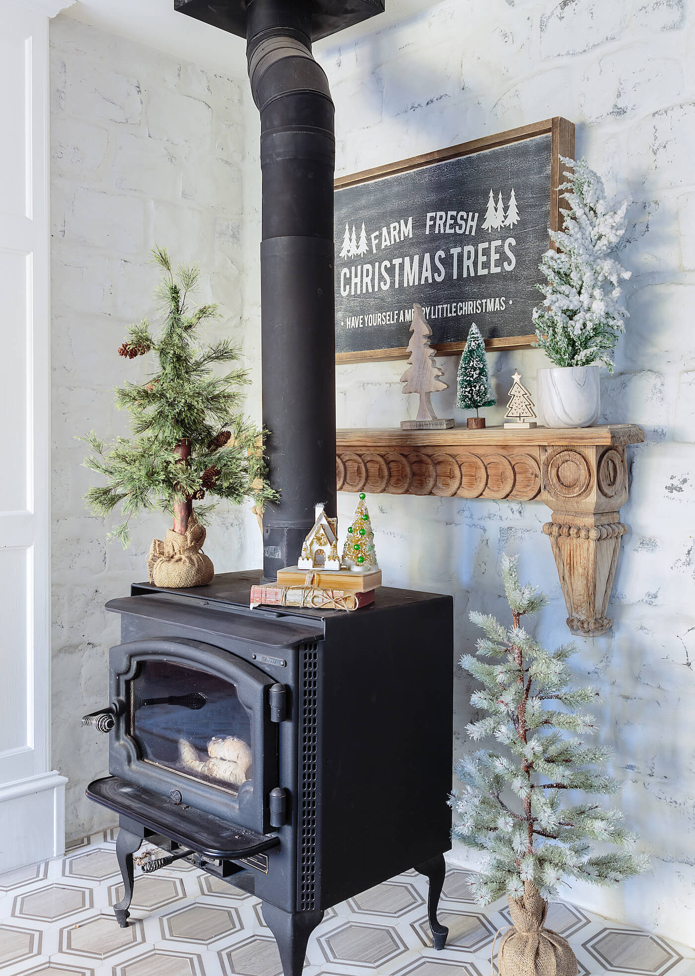 Rustic wood stove with Christmas Trees sign for a woodland Christmas theme.