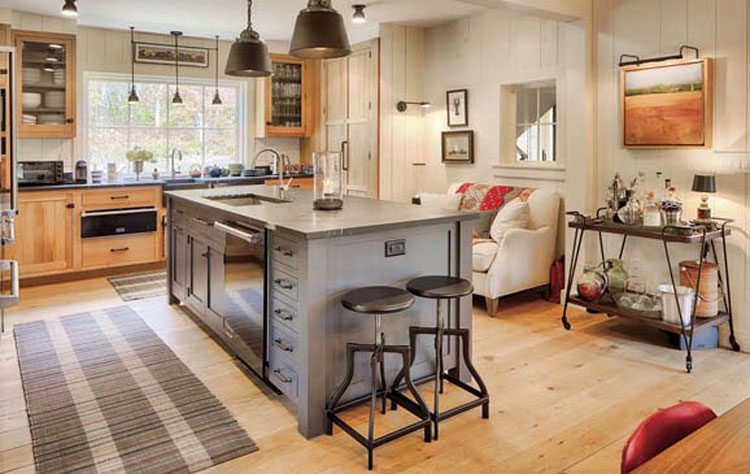 This farmhouse kitchen with wood flooring and off-white shiplap walls shows the warm lighting and cozy aesthetic that will be in our New Hampshire farmhouse.