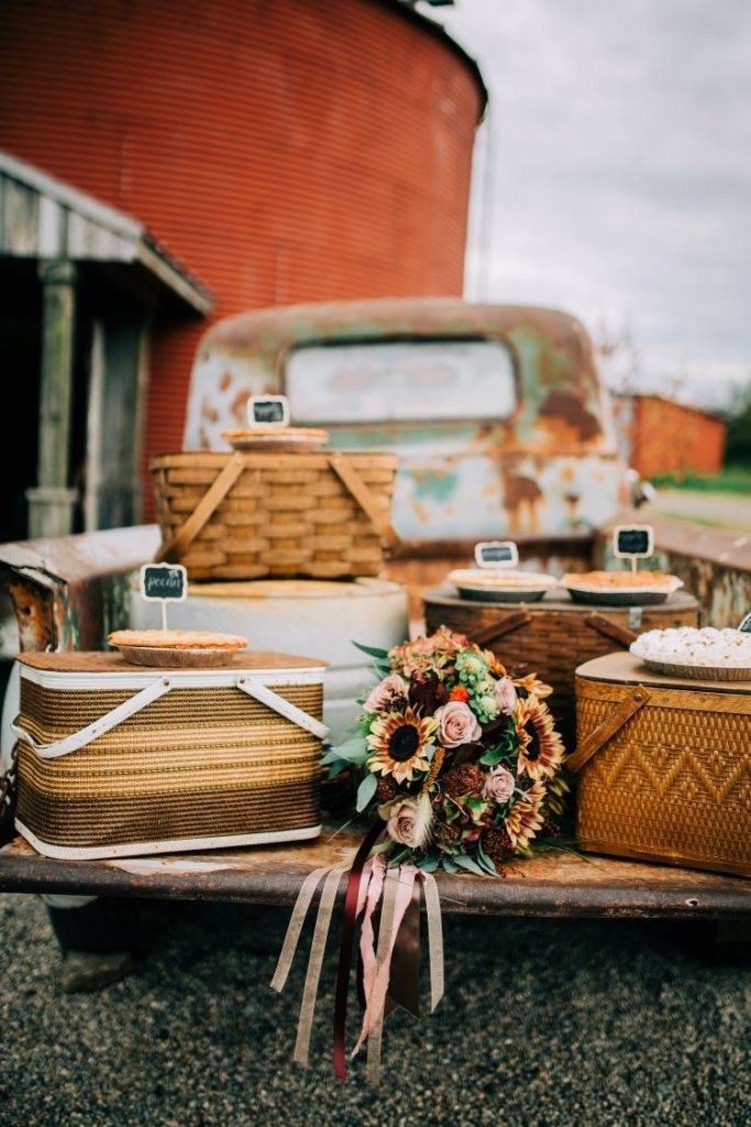 Dessert pie bar on a truck bed on top of picnic baskets