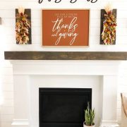 white fireplace with This Is Us sign and fall mantel