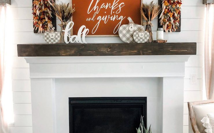 white fireplace with This Is Us sign and fall mantel