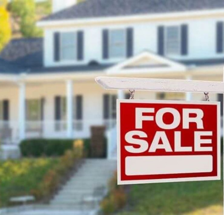 Picture of a for sale sign in front of a home