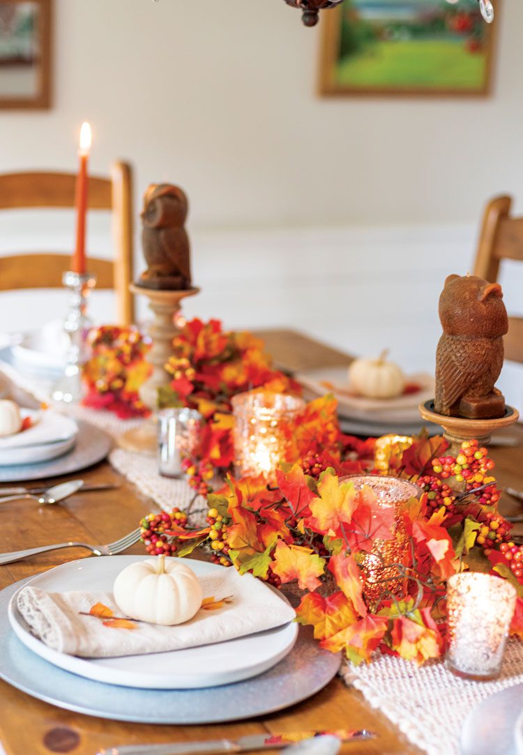 Nina uses bright and colorful fall leaves with candles to decorate her fall dinner table. Another step into her upcycled fall masterpiece!