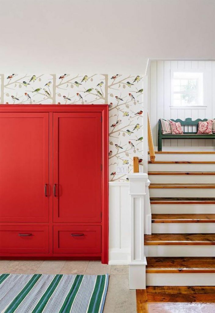 bright orange cabinetry with Schumacher bird wallpaper