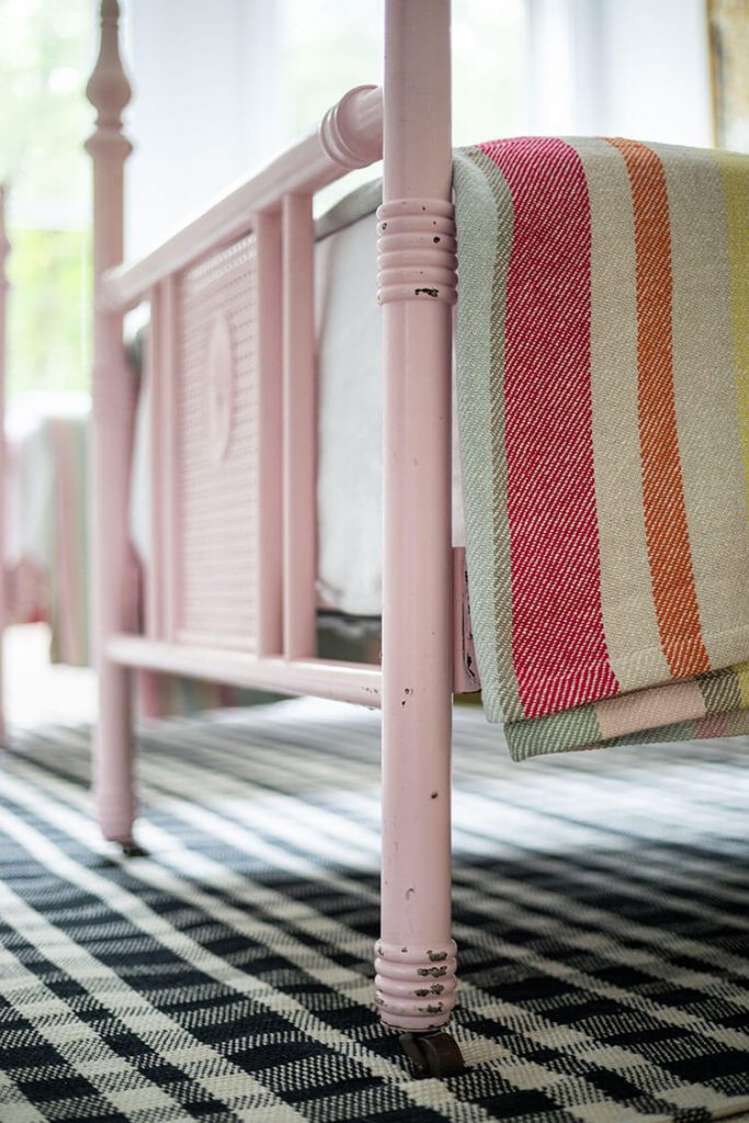 A short pink footboard is barely taller than the mattress itself, for where to put the bed