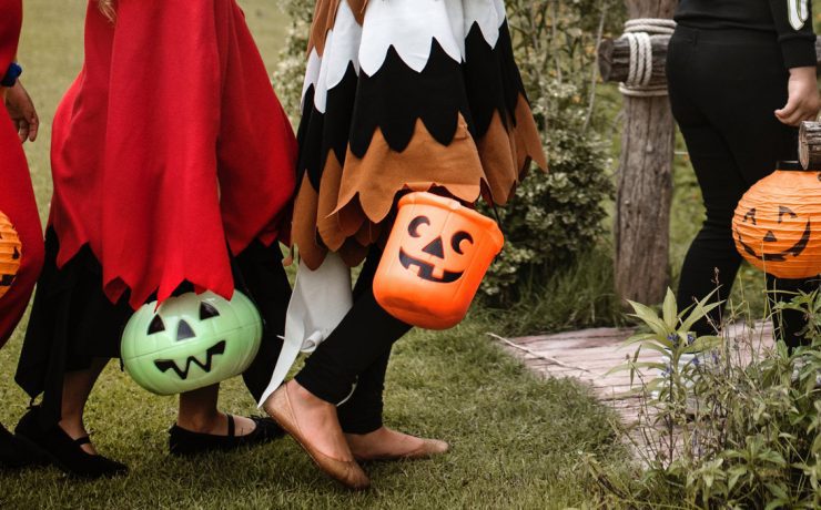 Children carrying candy-buckets in farmhouse costumes, ready for some trick-or-treating!