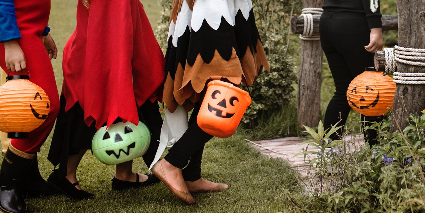 Children carrying candy-buckets in farmhouse costumes, ready for some trick-or-treating!