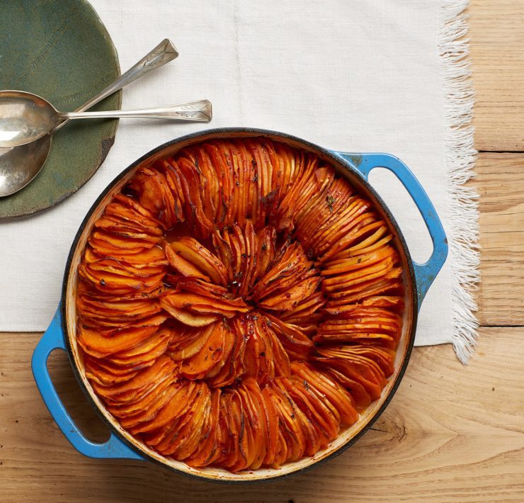 This Thanksgiving recipe has thinly sliced and spiced sweet potato slices placed into a pan like two circular rolls.